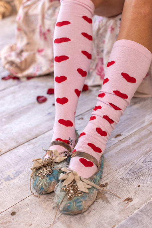 Magnolia Pearl artisan pink socks with red hearts and vintage whimsical tulle shoes on rustic floor