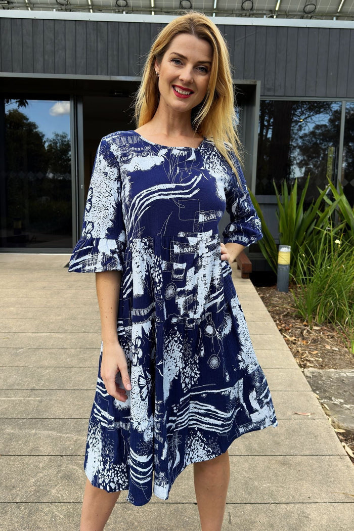 Navy and white abstract tunic dress by Hourglass, featuring a flowing design and stylish pattern, displayed on a hanger.