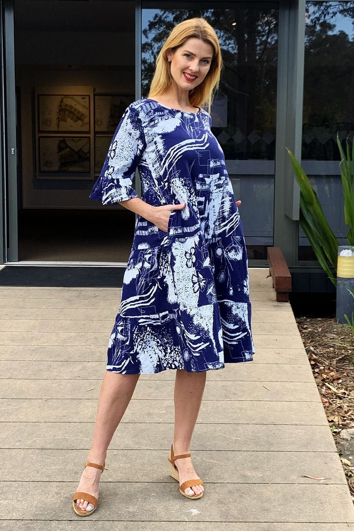 Navy and white abstract tunic dress by Hourglass, featuring a loose fit and stylish design, displayed on a hanger.