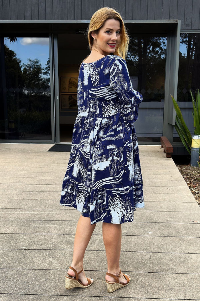 Navy and white abstract print tunic dress by Hourglass, featuring a flowy design and long sleeves, displayed on a hanger.