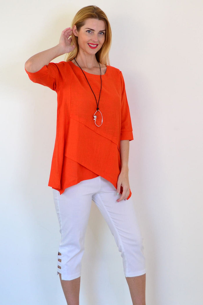 Orange layered linen blend tunic top by Ruby Rain displayed on a hanger with visible layered design and relaxed fit.