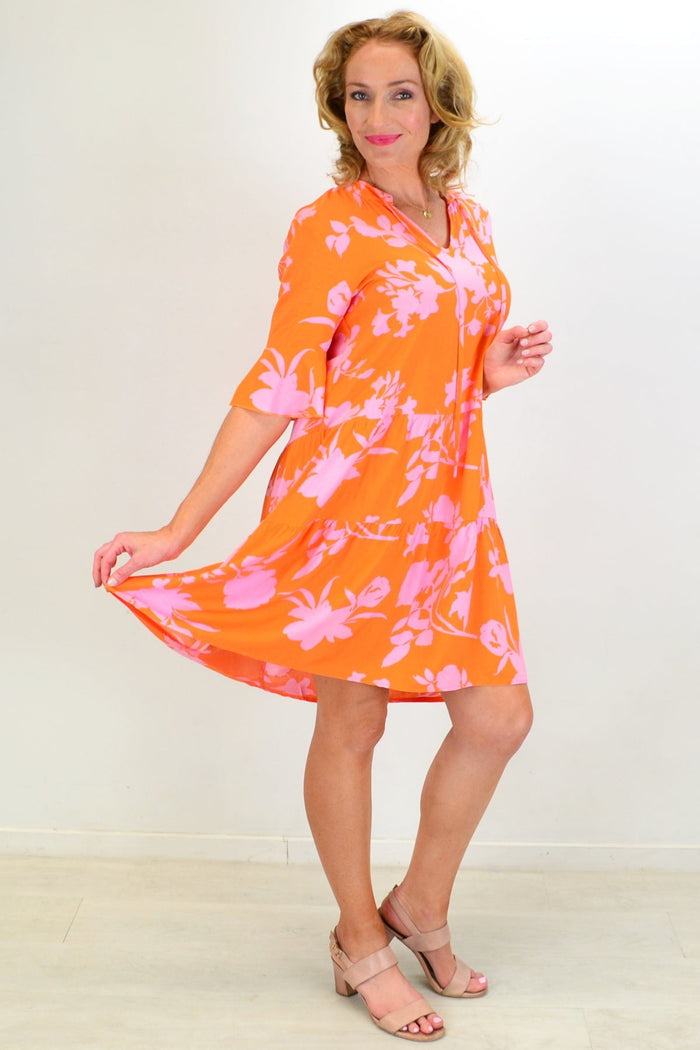 Peony orange maple leaf tiered dress tunic displayed on a hanger with detailed fabric texture and vibrant leaf pattern.