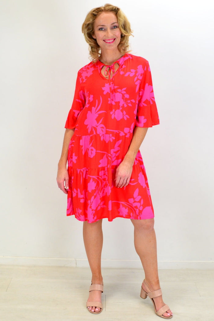 Pink Maple Leaf Tiered Dress Tunic by Peony, featuring layered fabric and a flowy silhouette, displayed on a hanger.