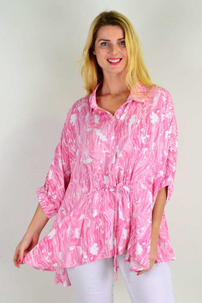 Pink River relaxed fit tunic blouse by Hourglass, shown on a hanger with soft fabric and casual style.