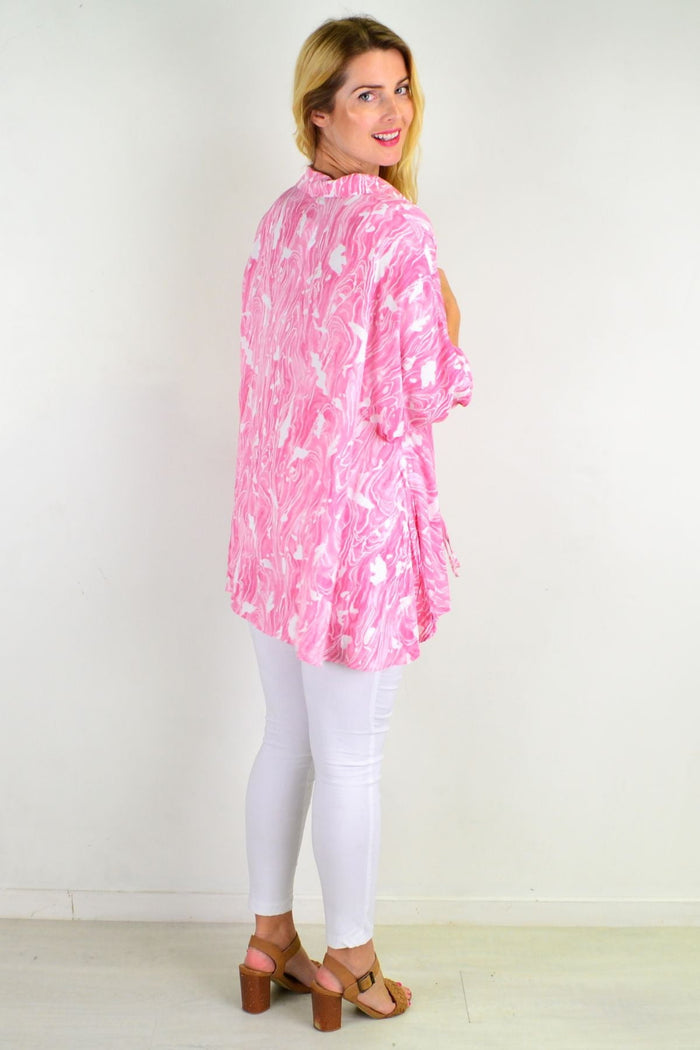 Pink River relaxed fit tunic blouse by Hourglass, shown on a hanger with soft fabric and casual, loose fit design.