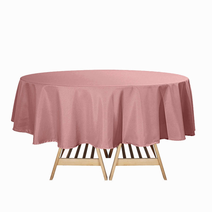 Pink round tablecloth draped elegantly over a wooden table.