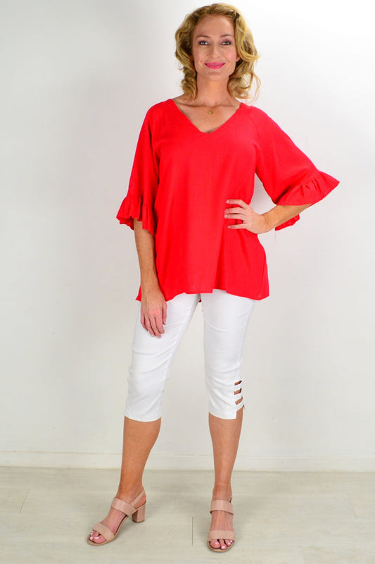 Red Razzle Dazel ruffle sleeve tunic top by Hourglass, featuring a vibrant red fabric with ruffled sleeve details.