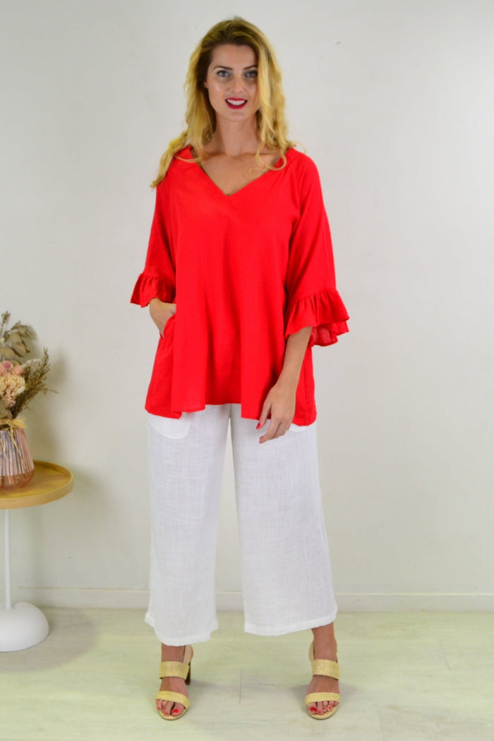 Red Razzle Dazel ruffle sleeve tunic top by Hourglass with flowing fabric and stylish ruffle details.