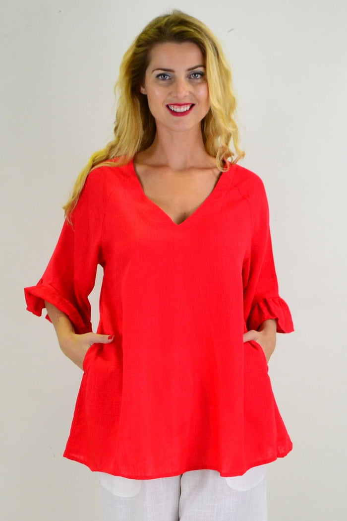 Red Razzle Dazel ruffle sleeve tunic top by Hourglass, featuring vibrant color and stylish ruffle details, displayed on a mannequin.
