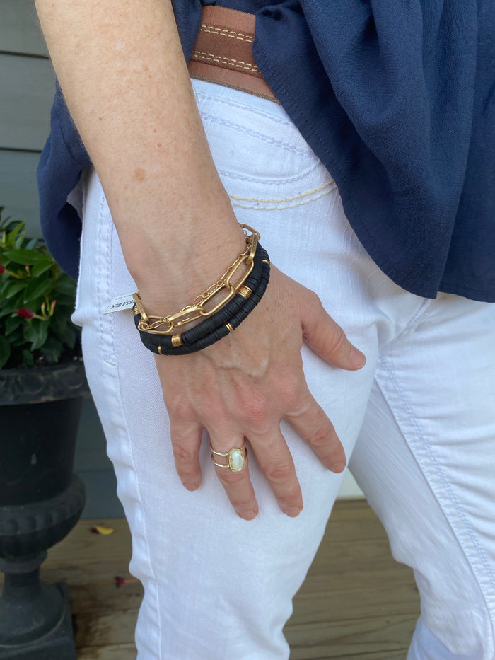 gold chains and black rubber and gold bracelet