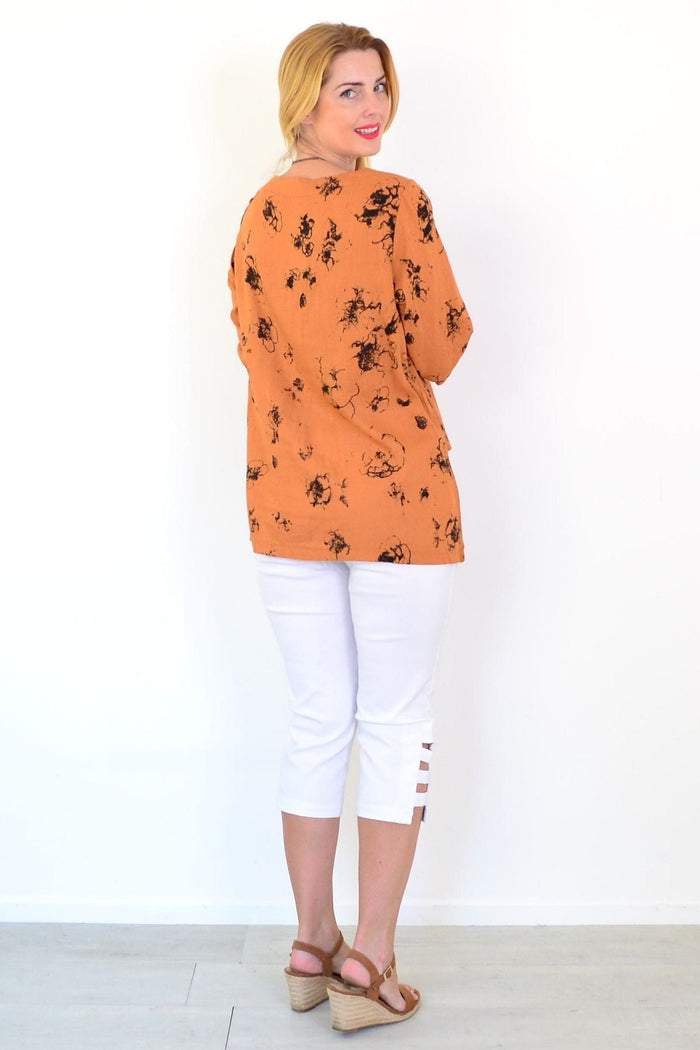 Rust-colored layered linen blend tunic top by Ruby Rain, featuring a relaxed fit and stylish design, displayed on a hanger.