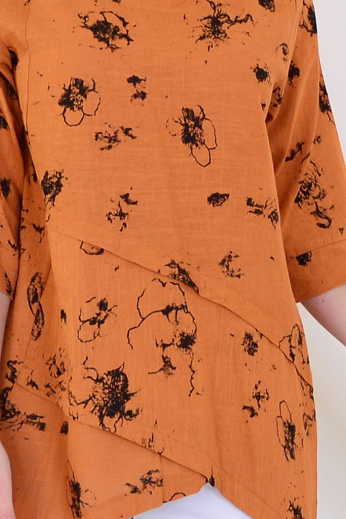 Rust layered linen blend tunic top by Ruby Rain, showing the flowing fabric, layered design, and relaxed fit on a mannequin.