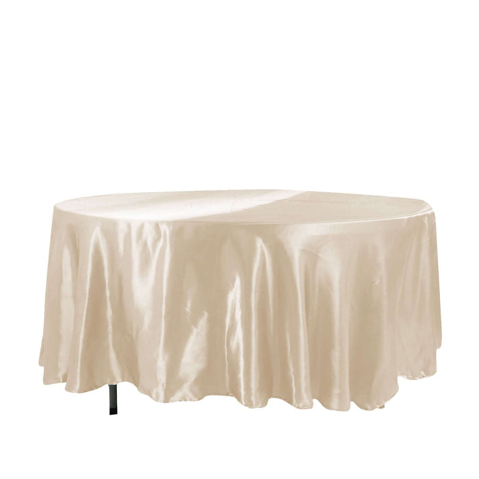Beige satin tablecloth draped over an oval table