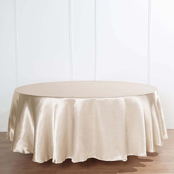 Round beige tablecloth draped elegantly over a circular table.