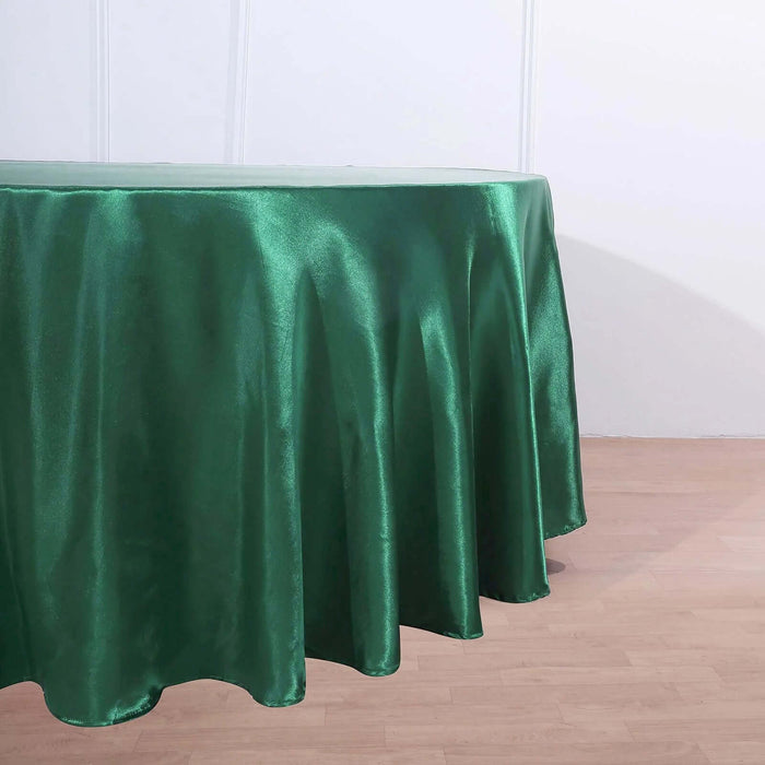 Green satin tablecloth draping elegantly over a table edge.