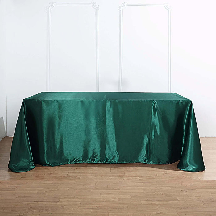 Green satin tablecloth draped elegantly over a table.