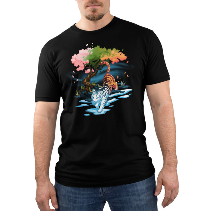 Premium Cotton T-shirt_TeeTurtle black Season Keeper apparel featuring a majestic tiger. The front half of the tiger is white and is stepping into winter, and snow, while the back half is orange. It is walking under a tree with different color leaves representing spring, summer, and fall.