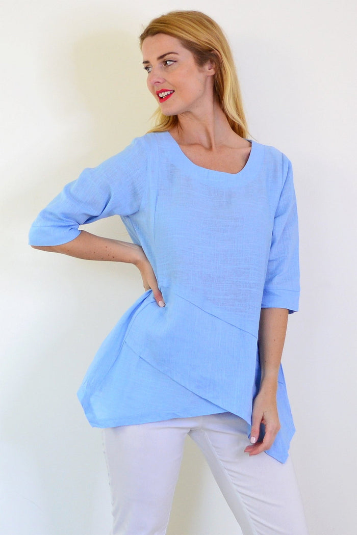 Sky blue layered linen blend tunic top by Ruby Rain, featuring a relaxed fit and stylish design, displayed on a hanger.