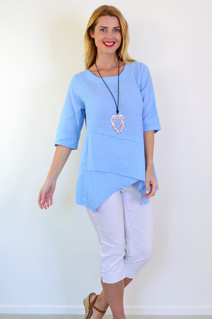 Sky blue layered linen blend tunic top by Ruby Rain, showcasing its relaxed fit and lightweight fabric.