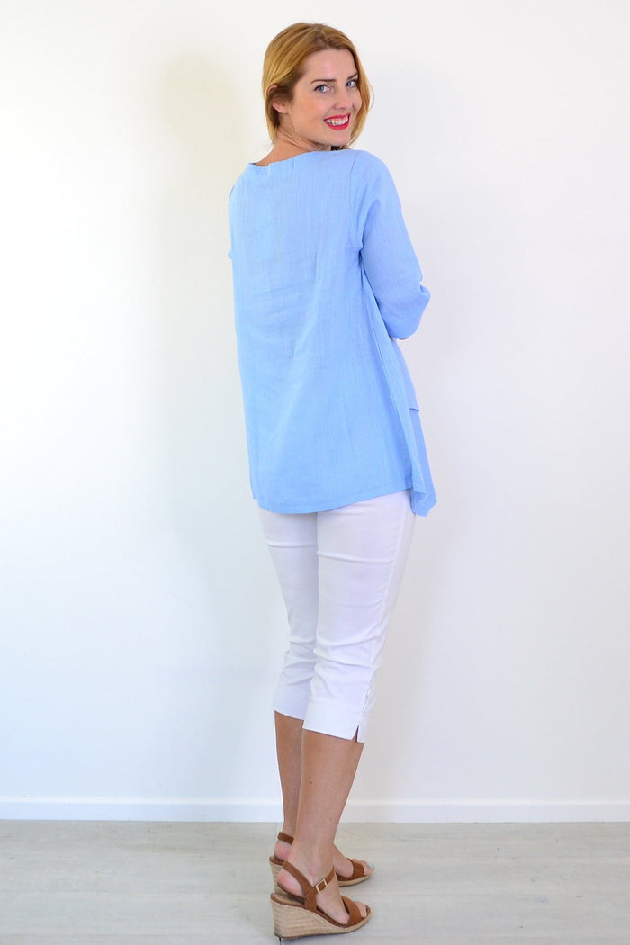Sky blue layered linen blend tunic top by Ruby Rain, featuring relaxed fit and casual style, displayed on a hanger.