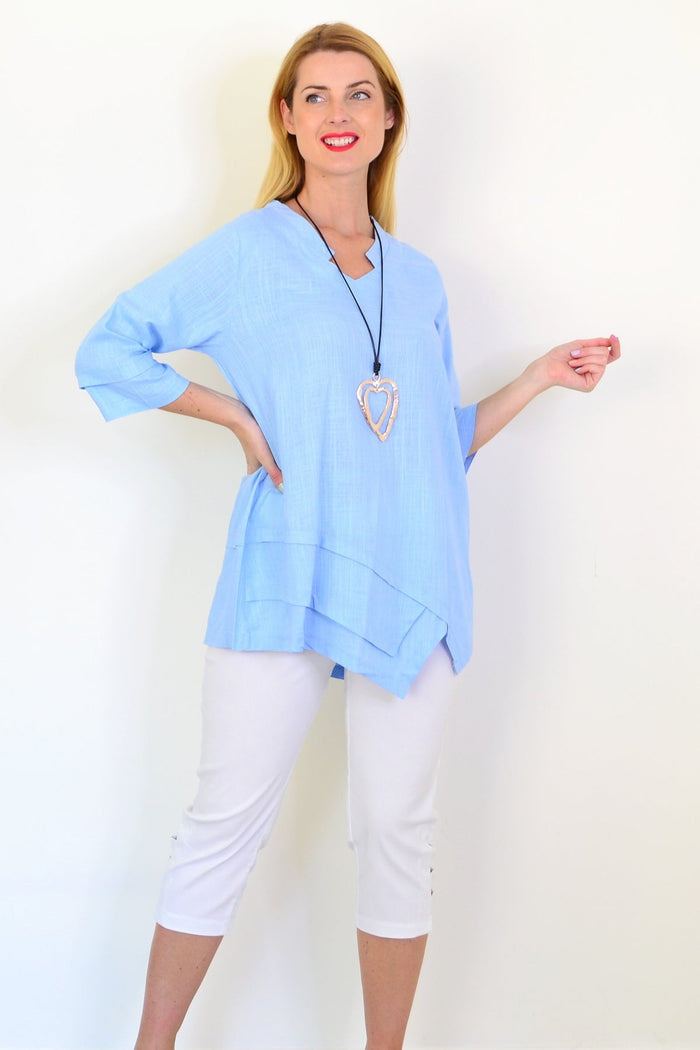 Sky blue linen blend tunic top by Ruby Rain, featuring a relaxed fit and soft fabric, displayed on a hanger.