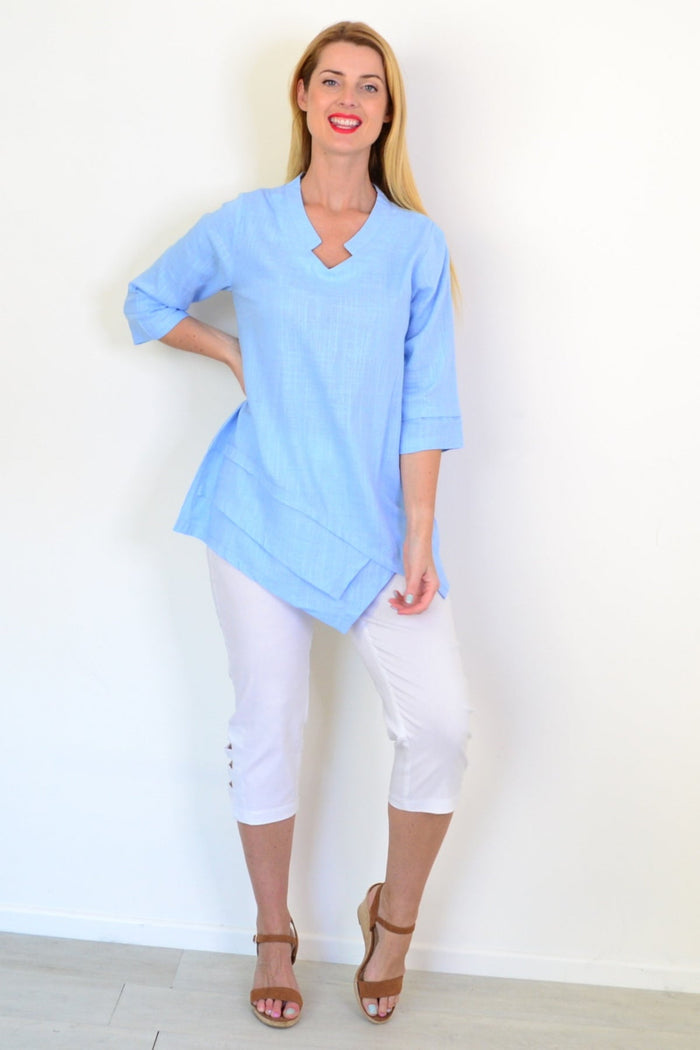 Sky blue linen blend tunic top by Ruby Rain, featuring a relaxed fit and lightweight fabric, displayed on a hanger against a neutral background.
