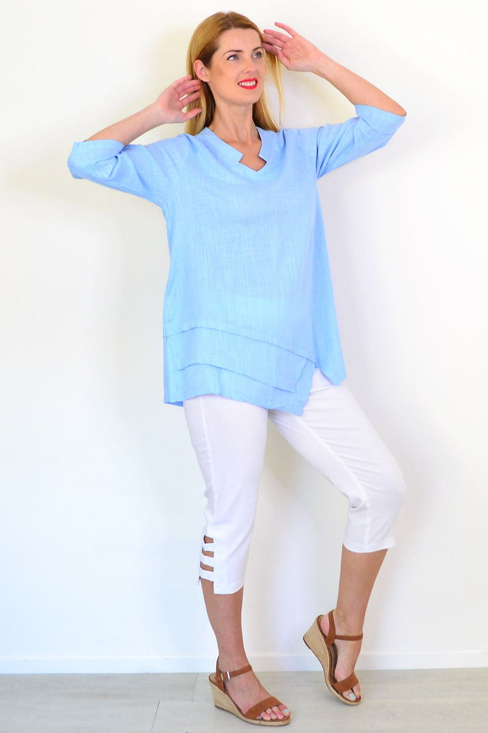 Sky blue linen blend tunic top by Ruby Rain, shown on a hanger with a relaxed fit and lightweight fabric.