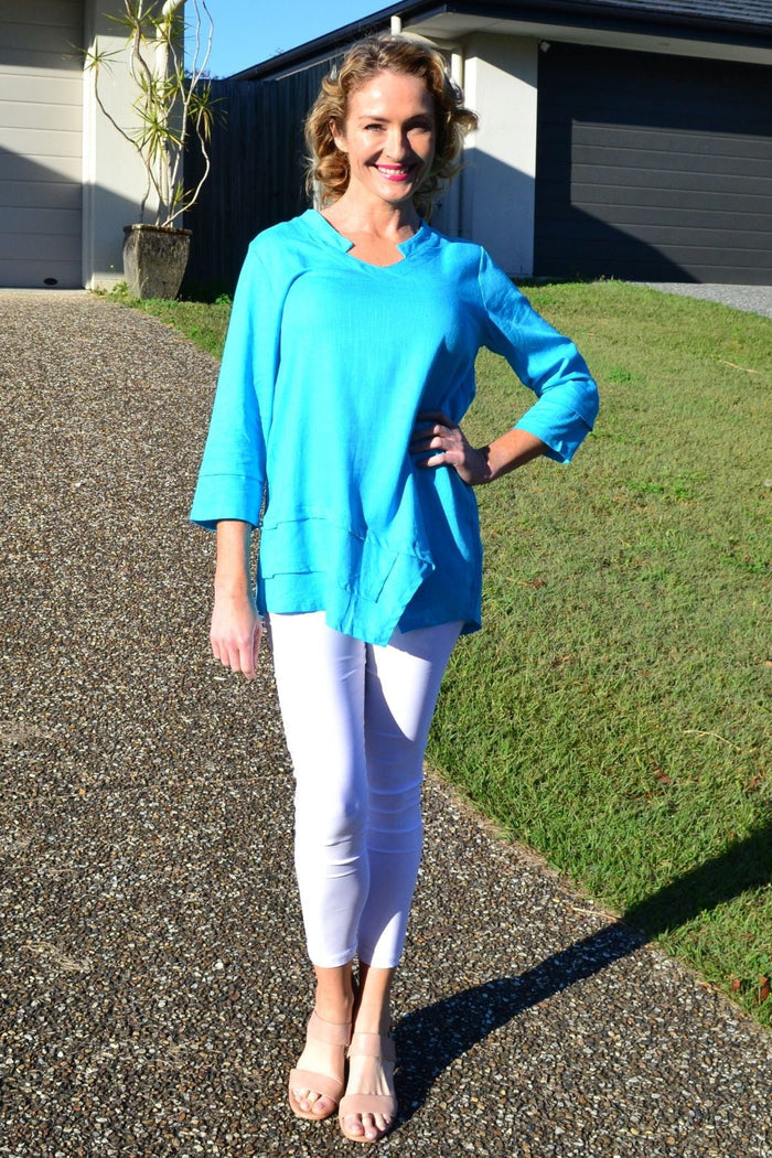 Sky blue linen cotton tunic top by Ruby Rain, featuring a relaxed fit and flowing fabric, shown on a hanger.