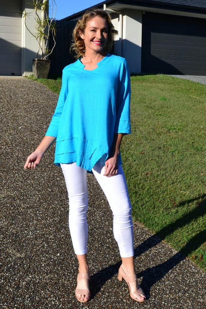 Sky blue linen cotton tunic top by Ruby Rain, casual women's tunic with relaxed fit and breathable fabric, displayed on a hanger.