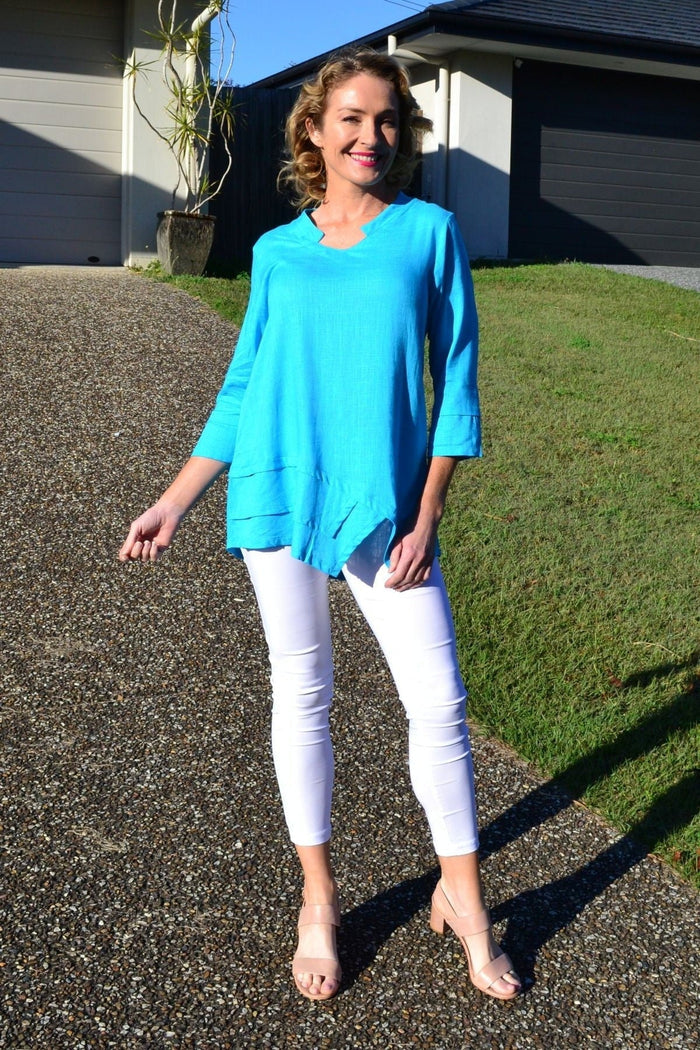 Sky blue linen cotton tunic top by Ruby Rain, featuring a relaxed fit and lightweight fabric, displayed on a hanger.