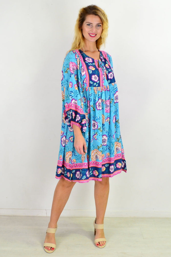 Soft blue Moroccan style boho tunic dress with intricate patterns and flowing fabric, perfect for casual and bohemian outfits.