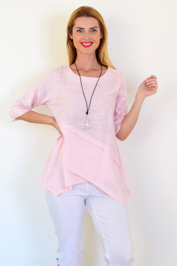 Soft pink linen blend tunic top from Ruby Rain, featuring a relaxed fit and lightweight fabric, shown on a hanger.