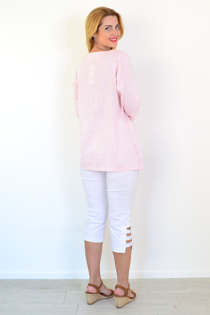 Soft pink linen blend tunic top by Ruby Rain displayed on a hanger, showcasing its relaxed fit and lightweight fabric.