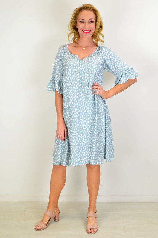 Hourglass Spotted Garden Shift Tunic Dress hanging on a wooden hanger with a floral pattern and relaxed fit.
