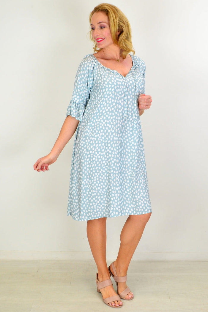 Hourglass spotted garden shift tunic dress displayed on a hanger with a floral pattern and relaxed fit.