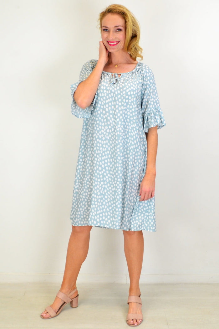 Hourglass spotted garden shift tunic dress hanging on a hanger with a floral pattern and relaxed fit.