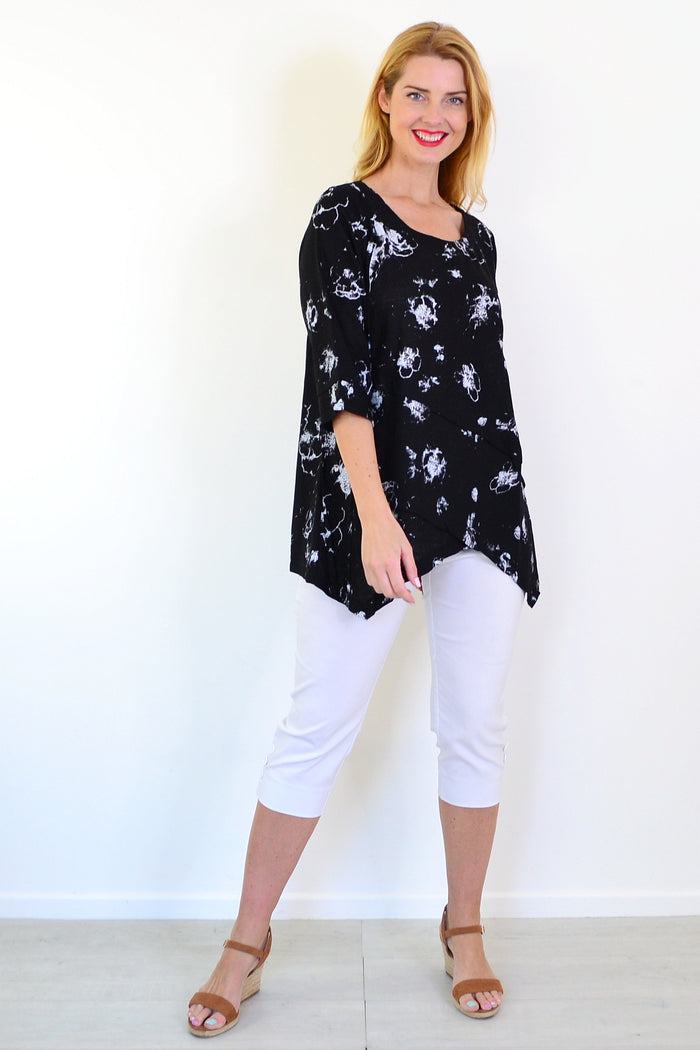 Starburst linen blend tunic top by Ruby Rain, featuring a relaxed fit and vibrant pattern, displayed on a hanger.