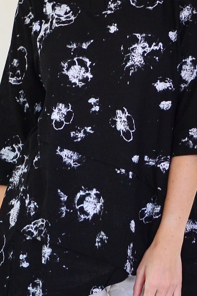 Starburst linen blend tunic top by Ruby Rain, featuring a loose fit and vibrant pattern, displayed on a hanger with a neutral background.