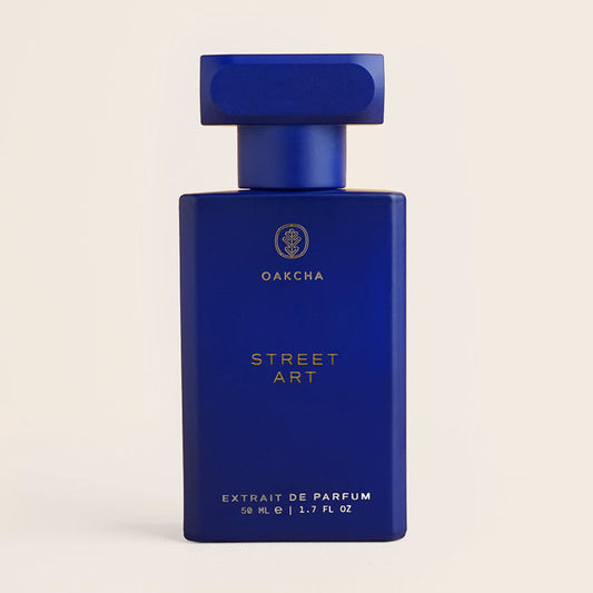 Front view of Street Art perfume bottle showing matte cobalt blue rectangular bottle and square cap on beige background