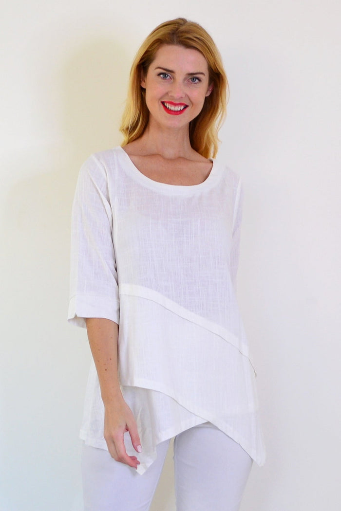 White layered linen blend tunic top by Ruby Rain with flowy fabric and layered design, displayed on a hanger against a neutral background.