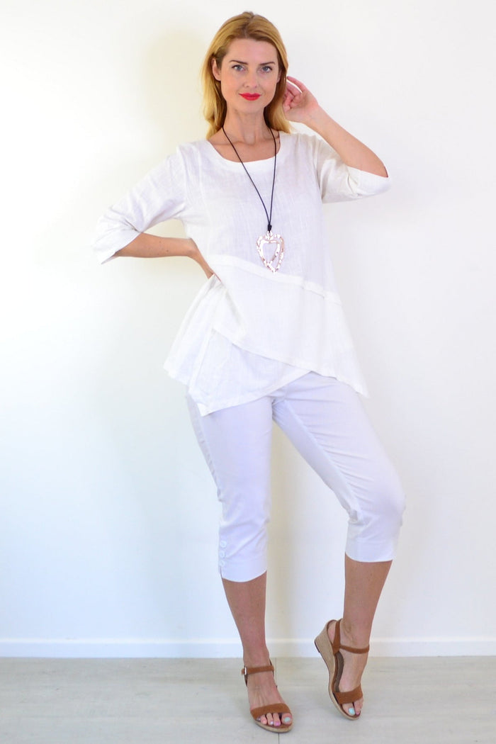 White layered linen blend tunic top from Ruby Rain, featuring a relaxed fit and stylish design, shown on a hanger.