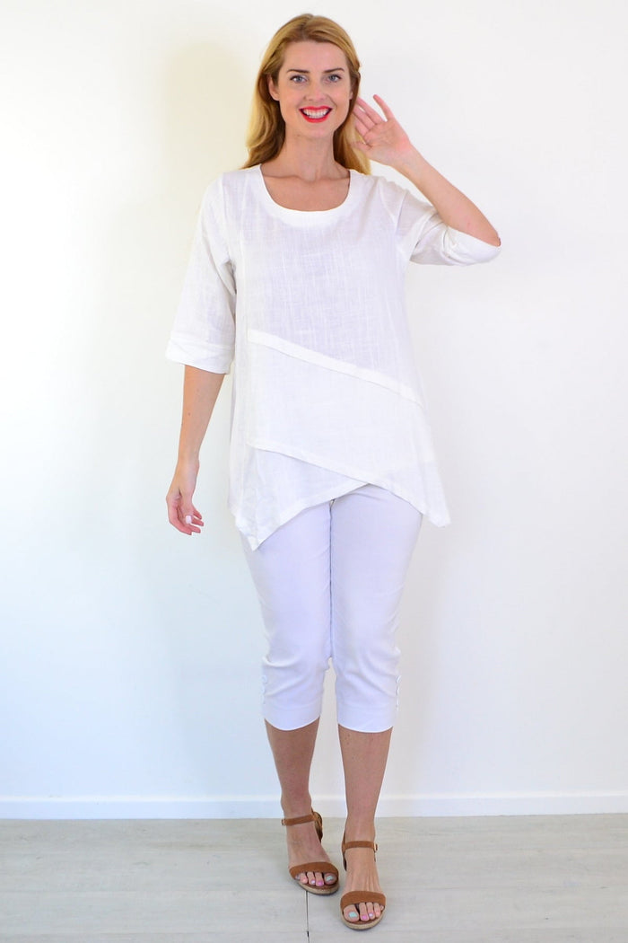White layered linen blend tunic top by Ruby Rain featuring a relaxed fit and flowing design, displayed on a hanger.