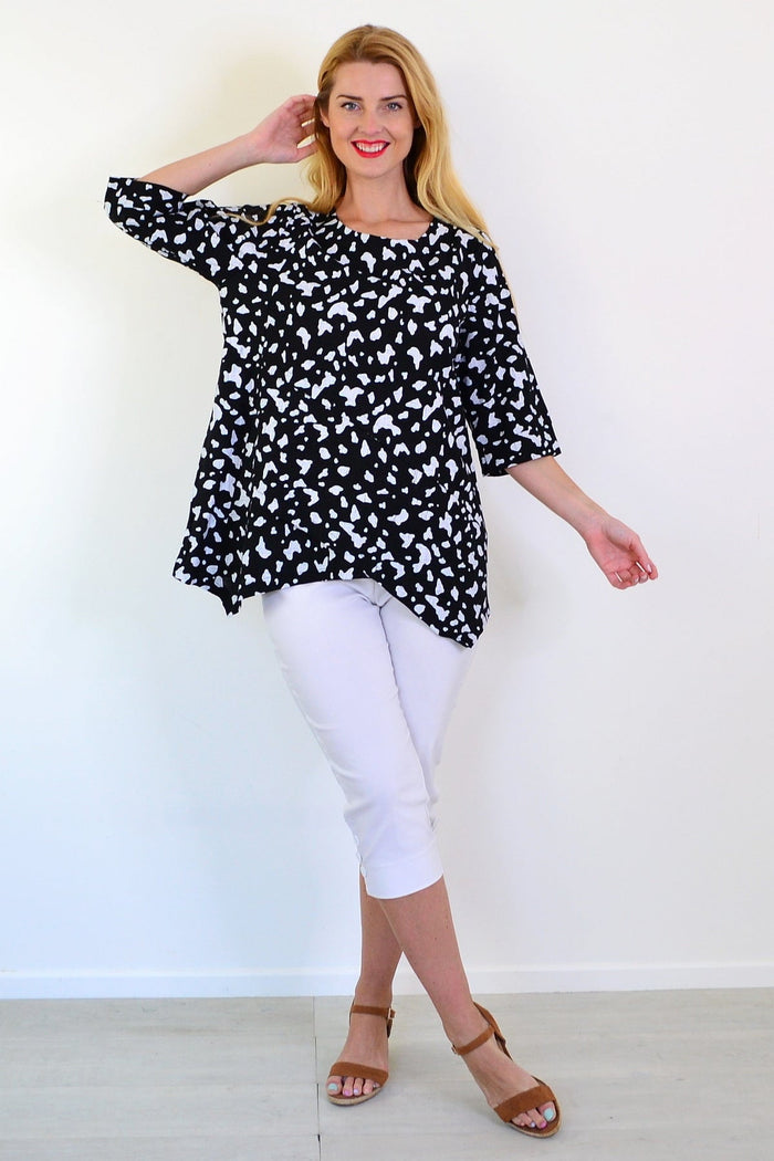 White paint splash linen blend tunic top by Ruby Rain, featuring a relaxed fit and artistic design, displayed on a hanger.