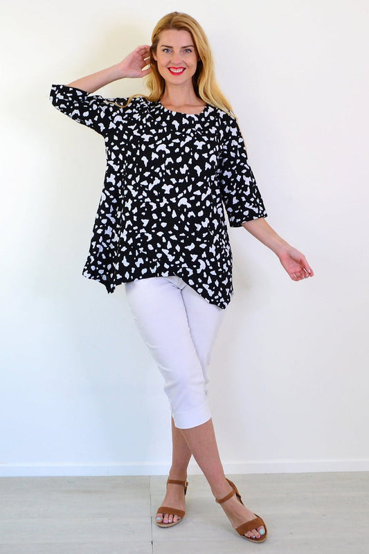 White paint splash linen blend tunic top by Ruby Rain, featuring a relaxed fit and artistic design, displayed on a hanger.