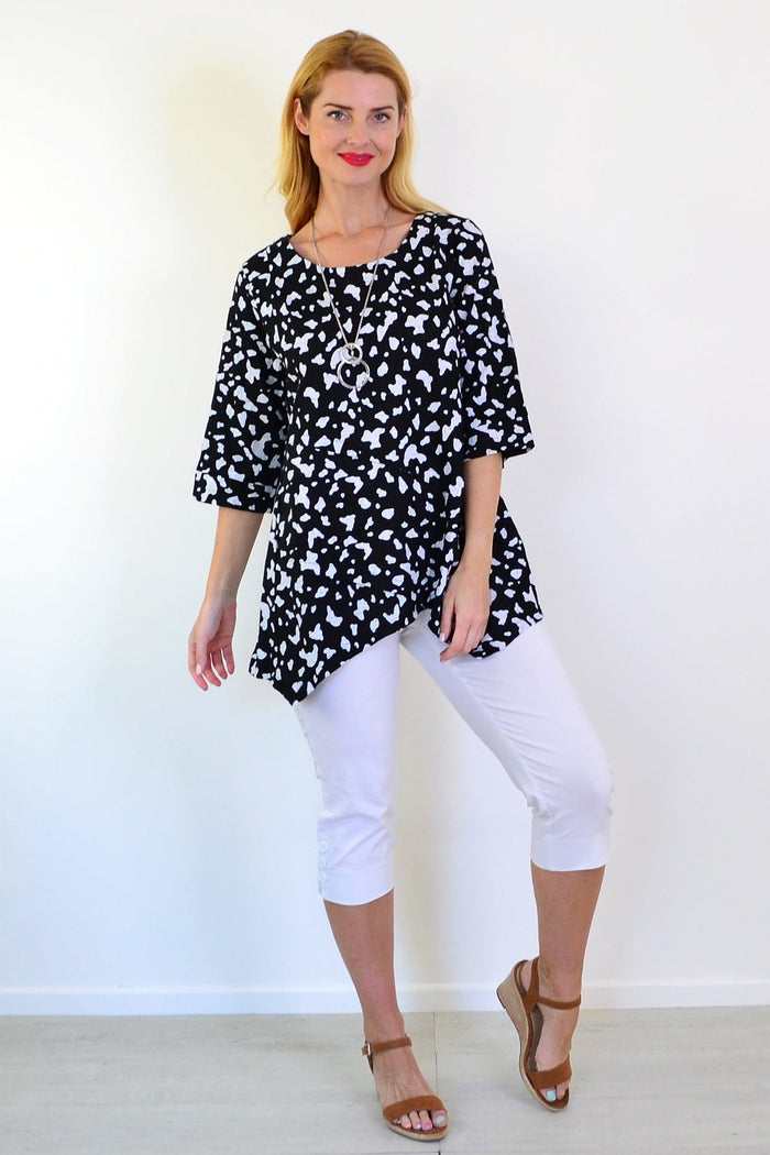 White paint splash linen blend tunic top by Ruby Rain displayed on a model, showcasing its relaxed fit and artistic design.