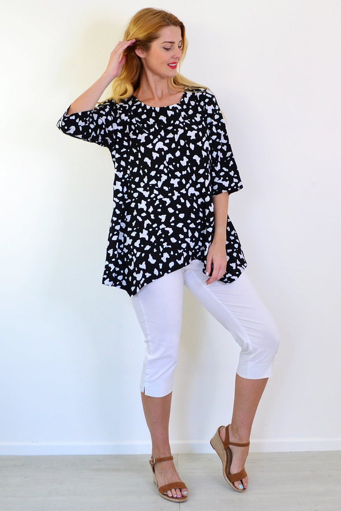 White paint splash linen-blend tunic top by Ruby Rain, featuring a relaxed fit and artistic design, displayed on a hanger.