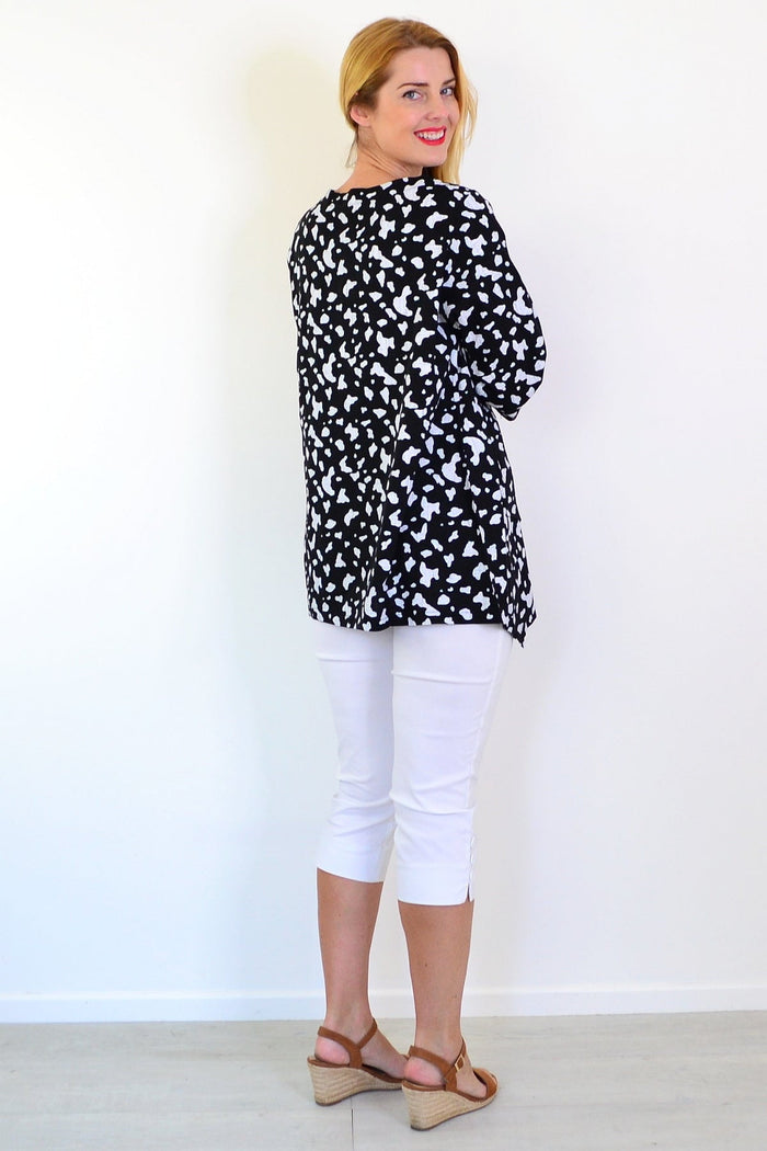 White paint splash linen blend tunic top by Ruby Rain, featuring relaxed fit and casual style, displayed on a hanger.