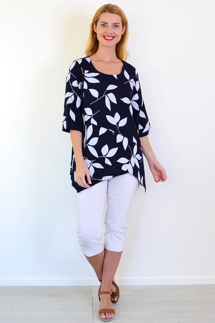 White Petals linen blend tunic top by Ruby Rain, featuring a relaxed fit and subtle petal pattern, displayed on a mannequin.