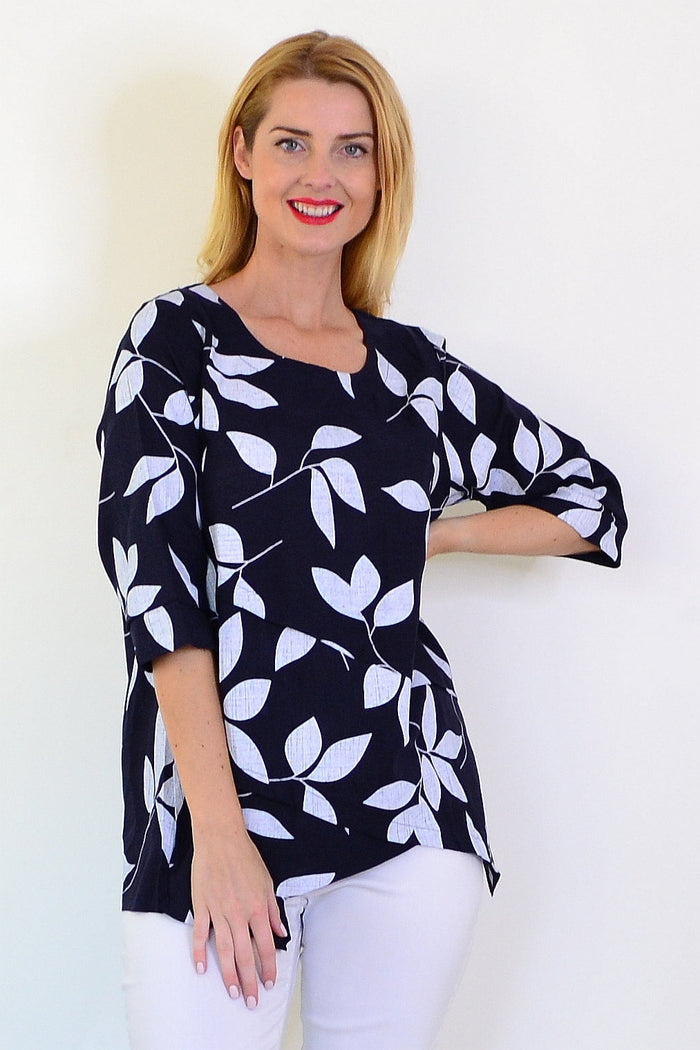 White Petals linen blend tunic top by Ruby Rain, front view showing flowy fabric and relaxed fit on a model.
