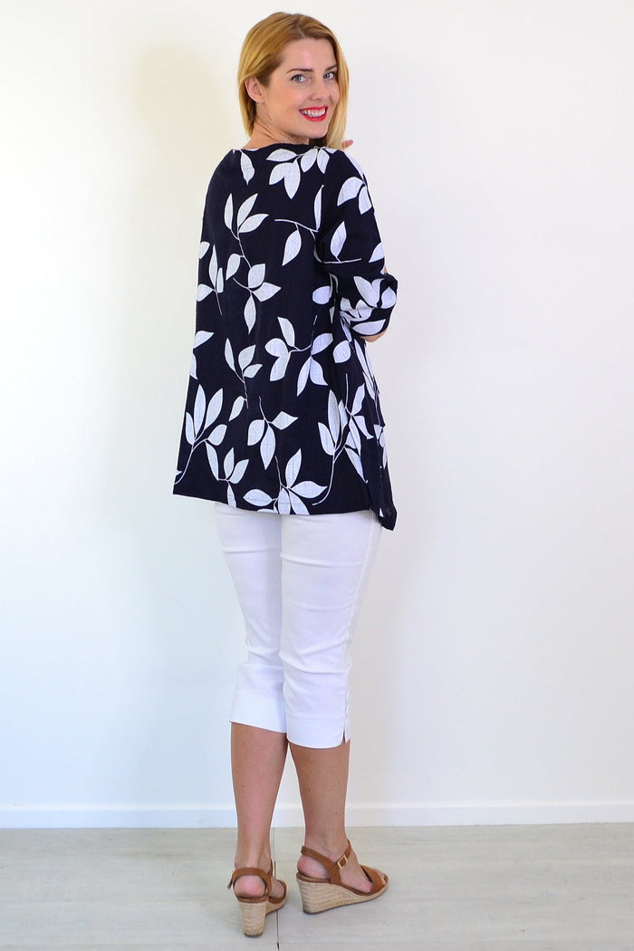 White Petals Linen Blend Tunic Top by Ruby Rain, featuring a relaxed fit and lightweight fabric, displayed on a hanger.